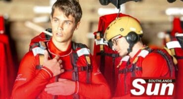 Two men dressed in wet suites checking their NSRI gear