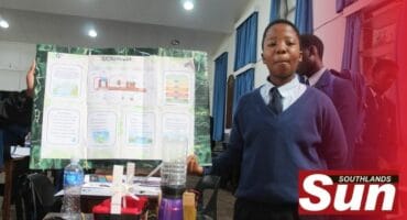Aphelele Ntinga poses with his poster and model Hydropower plant.