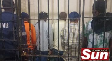 Some of the illegal foreigners at the Montclair police station after being charged with contravening Immigration Act.
