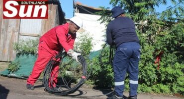 Municipal employees remove illegal connections at the informal settlement near Solomon Mahlangu Drive