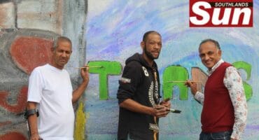 Painting a vision of change are Chief Mervin Damos, Kerwin Couch and Ashwin Desar.