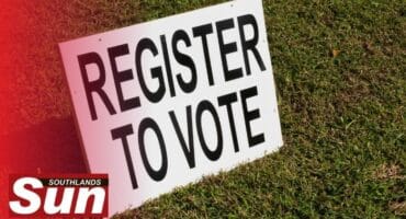 Register to vote board on grass