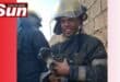 Senior firefighter Tevin Pillay carries the rescued puppies