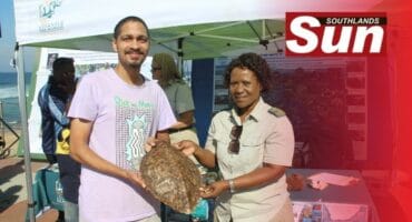 Joshua Horsley gets interesting lesson from Ezemvelo KZN Wildlife's Balungile Sibiya on the turtle's shell.
