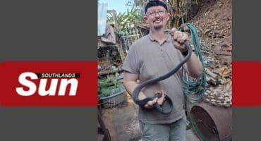 The Bluff based snake catcher Warren Dick with the captured black mamba.