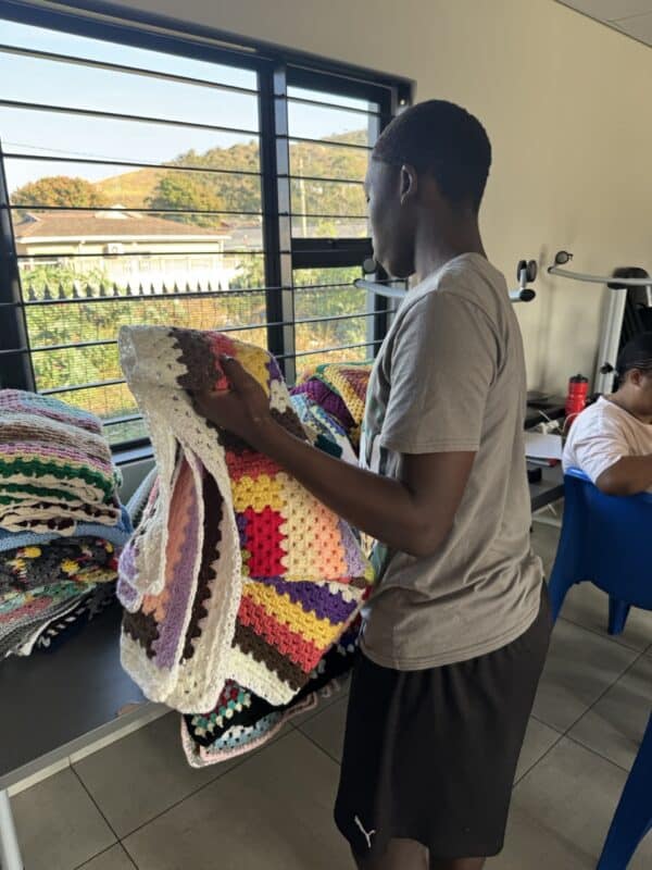 One of the children in iCare's facility chooses which blanket best suits him.