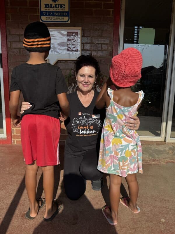 The SUN's editor Roelien D'Amico embraces two of the children at St Monica's Children's Home.