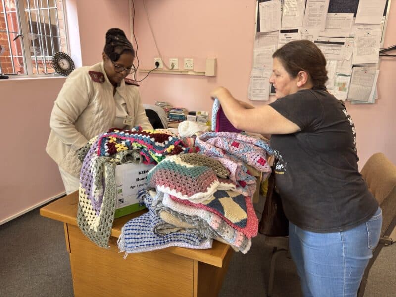 Wentworth Hospital's ward mother Patience Ngcobo and the SUN's Gerda MacGregor unload the blankets, booties, beanies and sweaters for the hospital.