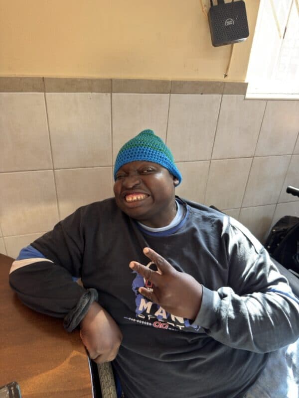Merewent Cheshire Home resident Amos Buthelezi flashes a smile in his new beanie.
