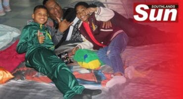 Cole Smith, Rainer Basdew and Tremaine Basdew get comfortable on their blanket.