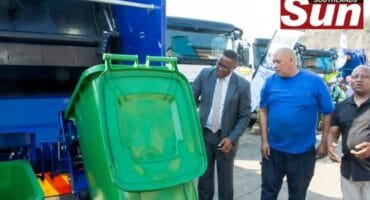Mayor of eThekwini Municipality, Cyril Xaba stands alongside municipal officials during the unveiling of the City's new waste management fleet.