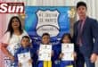 Departmental head Lavina Sewsunker and acting principal Ramesh Singh with the winners of the spelling bee Jeremiah Phillips, Kade Ganesh and Elliana Valayathum.