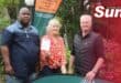 Ayanda Ndlela and SPAR's Brett Strydom hand over Sarie Bekker her prize for this month's garden competition.