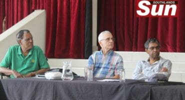 Desmond Dsa, Professor Stuart Batterman and Professor Rajen Naidoo at a community meeting in Merebank.
