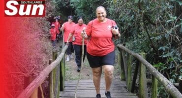 Lenore Tissong crosses the bridge tucked into the nature reserve.
