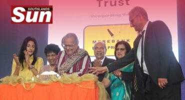 Ela Ghandi, with the support of professor Managay Reddi and the rest of the Merebank Book Project committee, cut the cake to celebrate the launch of the book.