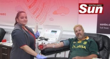 South African National Blood Service’s Jamie Louis helps regular donor Christiaan Bester.