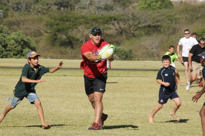 The dad's took their sons out on the rugby field for a game of touch rugby.
