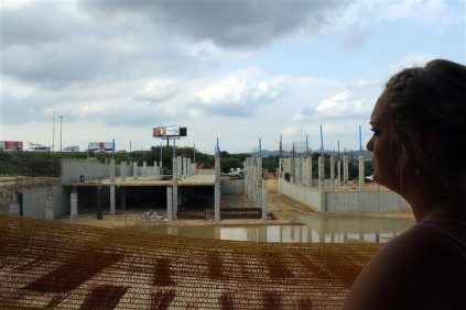 Ms Natania Tesnar looks to stagnant water that has accumulated on the contruction site behind Bakos Brothers. (Small)