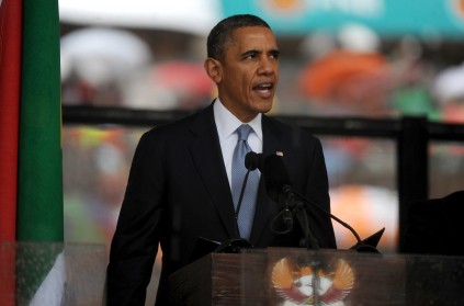 US President Barack Obama addresses mourners at a Nelson Mandela memorial service at the FNB stadium in Soweto on Tuesday, 10 December 2013. Mandela died on Thursday, aged 95, at his home in Johanne