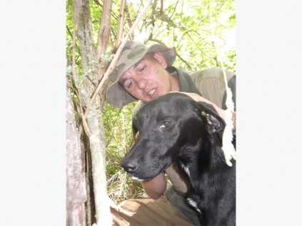 Mr JK Klopper calms am ensnared dog that was found in the Friedenheim area on Sunday.