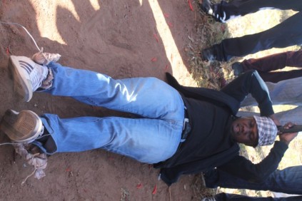 A policeman re-enacting how the victims were tortured.
