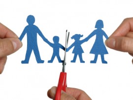 Man and womans hands cutting paper chain family concept for divorce and child custody battle