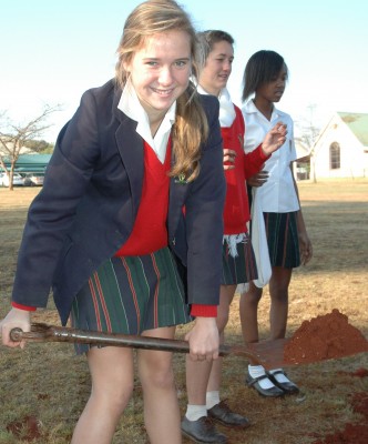 Skye Warrener planting a tree