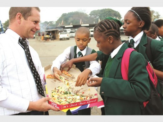 Pupils from Metropolitan Preparatory College enjoy some of the sponsored snacks.