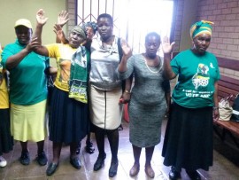 Praying women outside the courtroom.