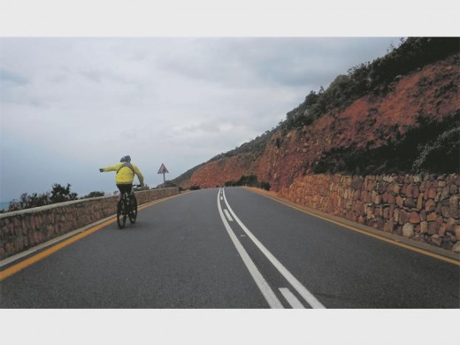 Rick points to a pod of dolphins during the penultimate stage between Hermanus and Bloubergstrand.