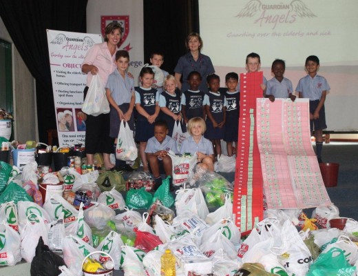 The teachers and pupils with the groceries.