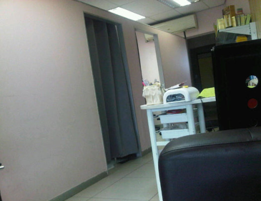 Two massage cubicles (one curtain closed, the other open) at the Jin Lu Chinese Beauty and Massage Salon