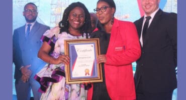 Fezekile Mosiane hands Letlhogonolo Zondi her 10 years service certificate.