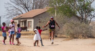 Damien Kuhn greets some passionate supporters during his run. > Photos: Supplied/Lion Sands Creative Lab