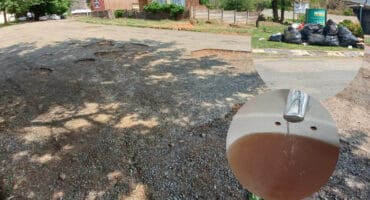 A pothole-ridden road in Emgwenya. Inserts: Residents are fed up with the uncollected garbage and dirty water.