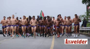The men make their way down the R40 in purple Speedos. > Photos: Blake Linder