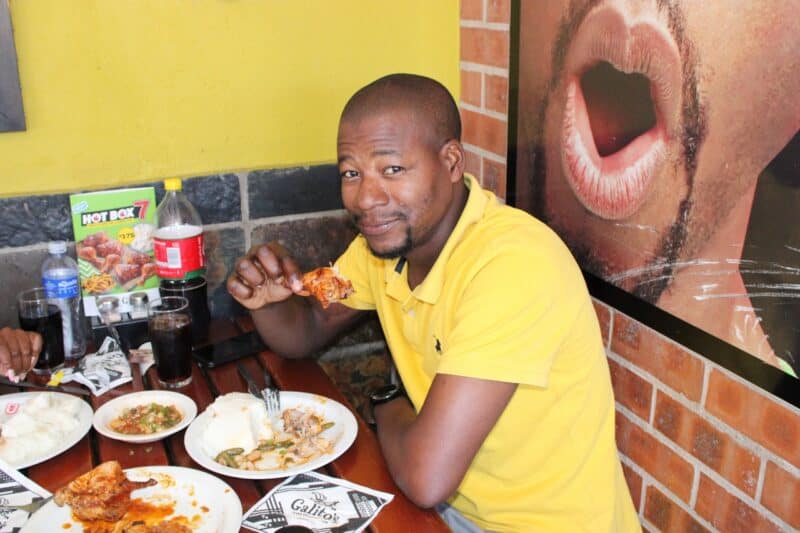 Sibusiso Maleni enjoys a quarter chicken.