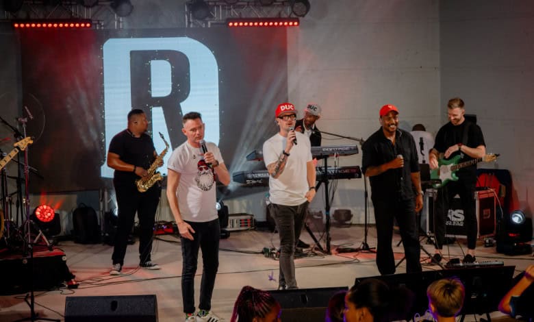 Graeme Watkins, Rubber Duc and Majozi perform on stage.