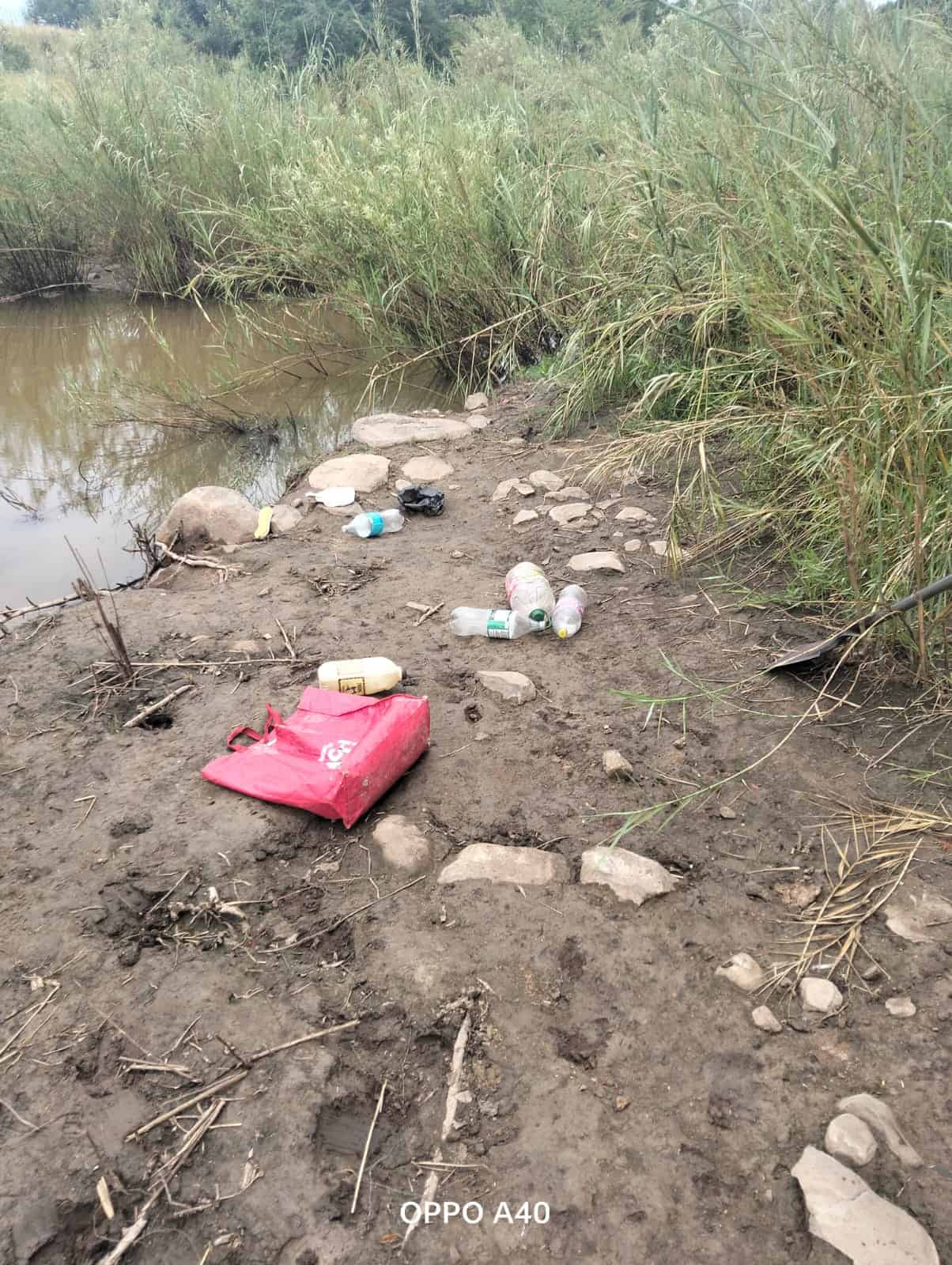 The water containers and the victim's bag that were found on the banks of the river.