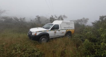 A forensic pathology vehicle at the scene where the burnt bodies were found. > Photo: Gia Radnai