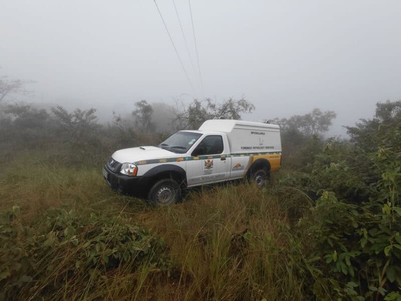 A forensic pathology vehicle at the scene where the burnt bodies were found. > Photo: Gia Radnai