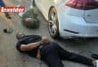 Two suspects lie on the ground.