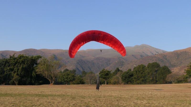 A paraglider completing his landing. >Photo: Joe Wolv