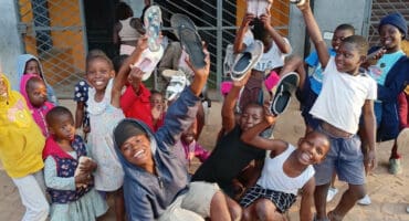 Children were happy to recieve their shoes. > Photo: Supplied/Phil Olckers