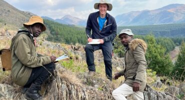 Christoph Chiburre, Armin Waldmann and Mfundo Mkhatshea collect data preserved in the sandstone of the Makhonjwa Mountains. > Photo: Supplied/Christoph Heubeck
