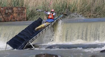 The 2026 Croc Canoe Marathon winner, Siseko Ntondini, shoots the weir. > Photo: Supplied/Jennie Dallas - PaddleSport Gauteng