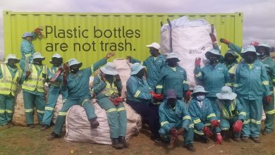Vezubuhle ZIP participants pose next to the PETCO-donated recyclables co...