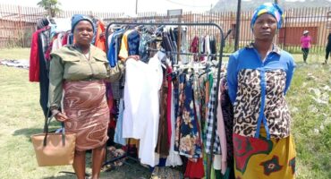 Maria Shongwe and Gina Maluleka receive clothes during the church service. Photos: Beatrice Shongwe.