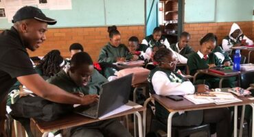 Similo Siyenga assists learners of Kaapmuiden Combined School with university applications.